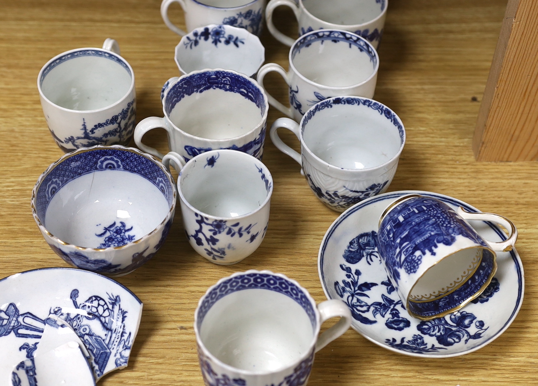 A collection of late 18th century Worcester, Caughley etc. blue and white coffee cups and saucers, the largest 12cm in diameter
